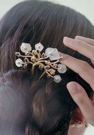 Hair accessory representing the exotic flower orchid carved in seashell with white-golden colour and coloured stone in 14 carat gold-plated silver. An intricated handcrafted Balinese creation to add to your charm.