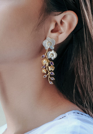 Anggrek chandelier earring, a representation of the exotic flower orchid carved in seashell with white-golden colour and coloured stone in 14 carat gold-plated silver. 