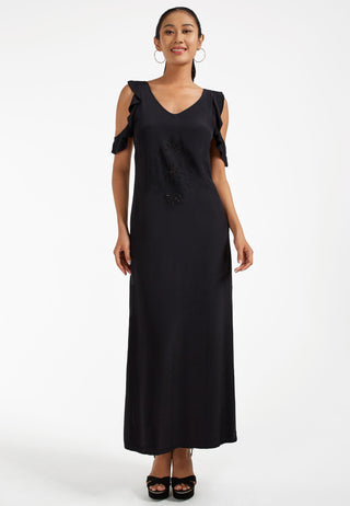 Attractive ankle length maxi dress, that has cold shoulder ruffled sleeves and side slit. The intricate Balinese handmade lace embroidery on the mid-riff is too beautiful. This dress is black in colour. 