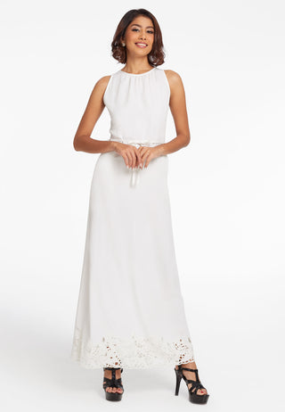 The model is wearing a long white sleeveless dress. Handcrafted traditional Balinese lacework and tie up detailing at the waist is the main feature of this elegant wear. 