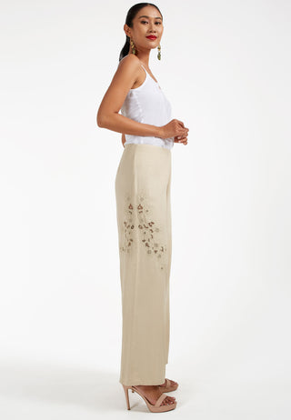 Studded with exquisite Balinese handmade lace embroidery on one side of the leg, ARIANA pant. These are loose flared pants made from linen. This pant is beige coloured.