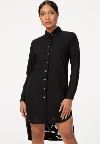 Full sleeved shirt dress with high low hemline decorated with traditional handmade Balinese lace embroidery work. The sleeves are cuffed, shell buttons add charm to it. It is in black colour.