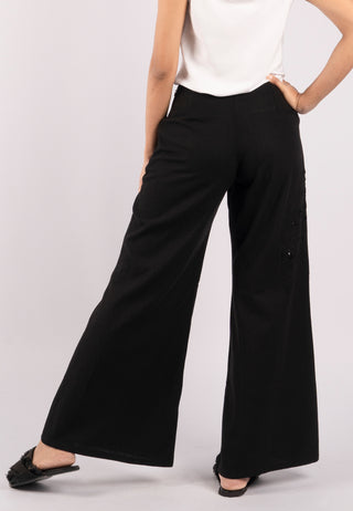 Studded with exquisite Balinese handmade lace embroidery on one side of the leg, ARIANA pant. These are loose flared pants made from linen. black coloured pant.