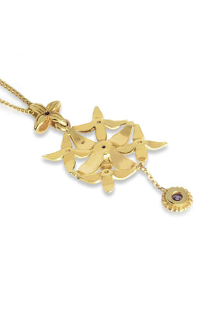 Inspired by the sacred Asoka tree, this elegant pendant has carved petals designed beautifully with a tiny stone danger in sterling silver and gold plated. 