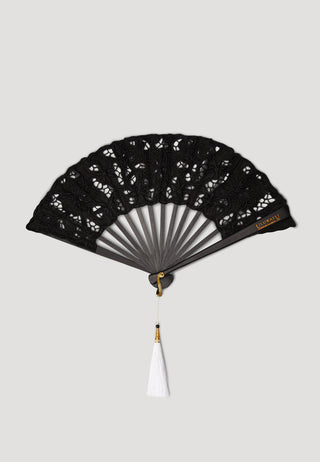 Black hand fan with Balinese embroidered leaf from ULUWATU having long white beaded tassels and black wooden ribs.