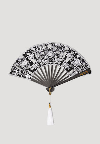 Stunning hand fan with black wooden ribs and black cotton leaf decorated with Balinese embroidery in white that complements well with long white beaded tassels. 