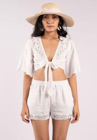 V-neck Spanish/Mexican inspired top with front knot pattern and butterfly sleeves. Traditional Balinese lace embroidery is handcrafted along the neck hemline. 