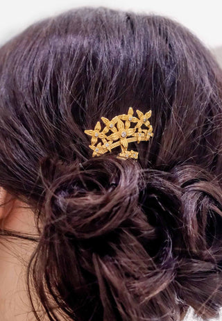 Tiny leaves of the sacred Asoka tree carved beautifully into a lovely hair piece studded with white stones in gold-plated sterling silver